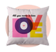 Decorative pillow with colorful 'LOVE' design and text on a pink background